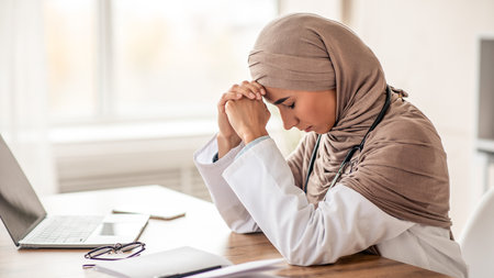 Exhausted woman doctor working in the clinic, side viewの写真素材