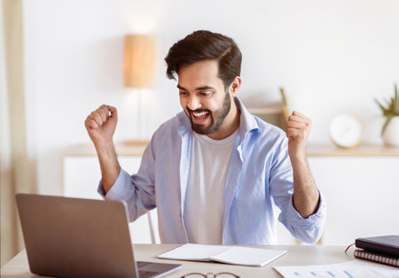 Promotion News. Overjoyed Arab Man Looking At Laptop Screen And Celebrating Successの写真素材
