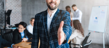 Successful Young Entrepreneur Stretching Hand For Handshake Standing In Office