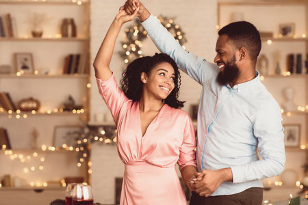 Smiling black man dancing with his womanの写真素材