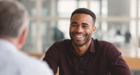 Business marketing conversation featuring a smiling man in a modern office setting Generative AIの素材