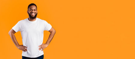 Happy African Man Standing Posing Near Empty Space, Yellow Backgroundの写真素材