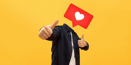 Engaging social media interaction with a heart icon and thumbs up gestureの写真素材