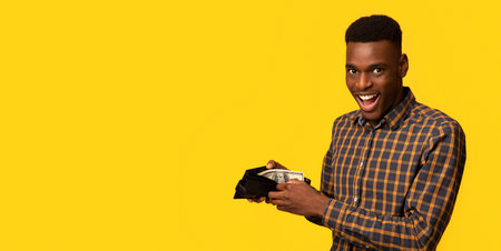 Successful Financial Planning. Joyful Black Guy Showing Wallet Will Dollar Cash Moneyの写真素材