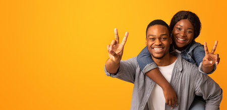 Cheerful Black Lovers Having Fun, Embracing And Showing Peace Gestures At Cameraの写真素材