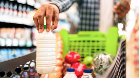 Guy Doing Grocery Shopping Putting Products In Cart In Supermarketの写真素材