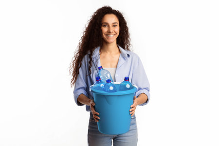Lady Holding Garbage Bucket With Plastic Bottles Over White Backgroundの写真素材
