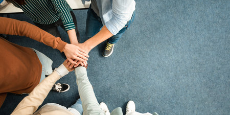 Above view of diverse people putting hands together