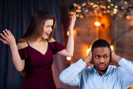Young Interracial Couple Arguing During Dinner Date In Restaurant