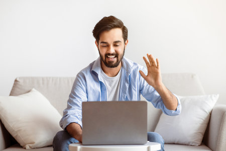 Online Meeting. Cheerful Arab Man Making Video Call With Laptop At Homeの写真素材