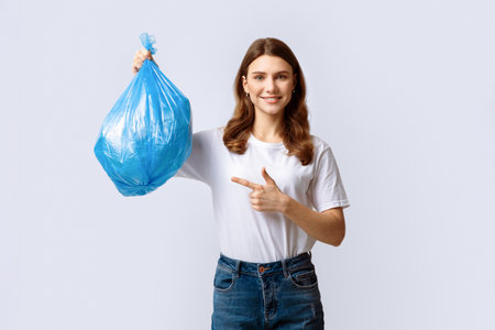 Woman recycling plastic bag in eco-friendly effort at homeの写真素材