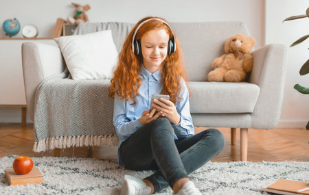 Girl wearing headphones enjoying music with phoneの写真素材