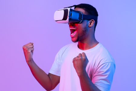 Excited Black Man In VR Headset Glasses Playing Cyber Games, Neon Light
