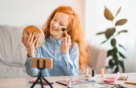 Red-Haired Teen Girl Recording Her Beauty Blog, Doing Makeupの写真素材