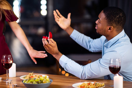 Proposal Rejection. Woman Leaving Black Boyfriend In Restaurant After He Proposed Marriageの写真素材