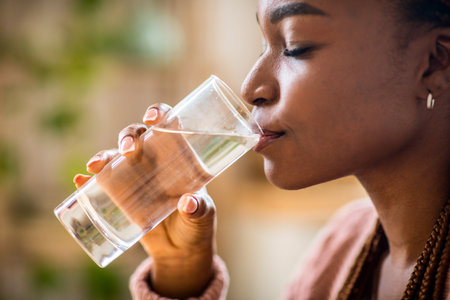 Body Hydration Concept. Closeup Of Black Millennial Female Enjoying Mineral Waterの写真素材