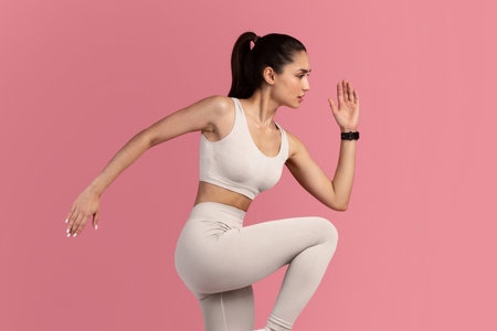 Young Woman Running And Exercising Isolated On Pink Background