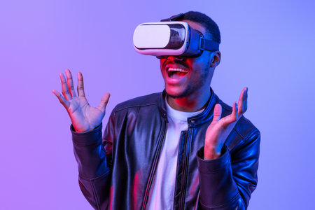 Excited African American Guy In VR Glasses Enjoying Virtual Reality Experienceの写真素材
