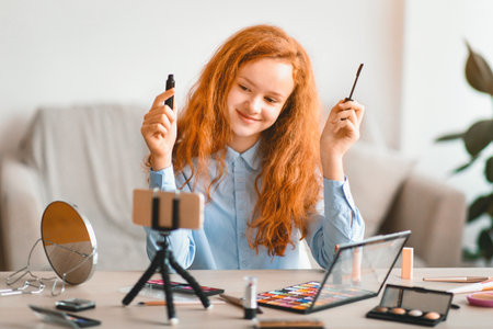 Smiling Teen Girl Recording Her Beauty Blog, Doing Makeupの写真素材
