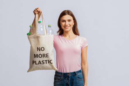 Woman promotes eco-friendly recycling habits while smiling with reusable bag