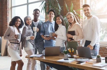 Happy young business team posing in office during working dayの写真素材