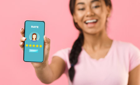 Happy girl showing blank screen smartphone, mockup for advertisementの写真素材