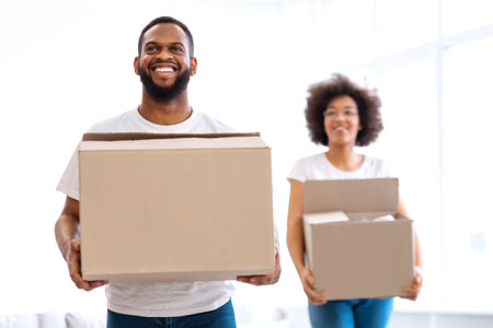 African American Couple Moving Carrying Cardboard Boxes Entering Own House