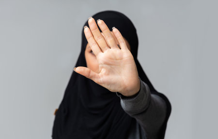 Muslim woman in hijab making stop gesture with her handの写真素材