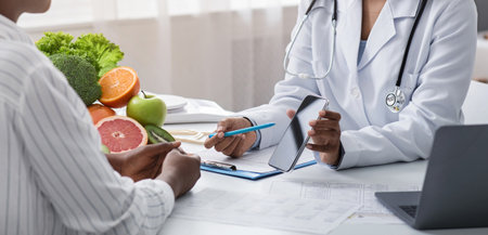 Nutritionist showing patient blank smartphone screen while consultancyの写真素材