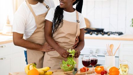 Loving Black Couple Cooking Healthy Lunch In Kitchen Together And Drinking Wineの写真素材