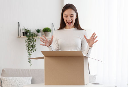 Positive client satisfied when open cardboard box parcelの写真素材