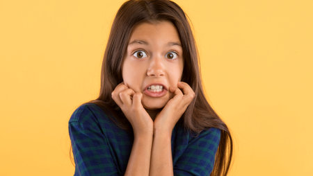 Surprised shocked little girl looking at cameraの写真素材