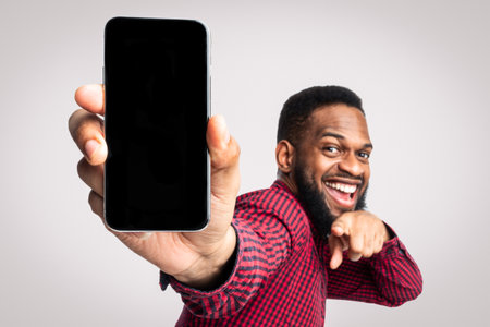 African Man Showing Phone Blank Screen Recommending Application, White Backgroundの写真素材