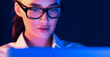 Overwork. Woman working on laptop at night