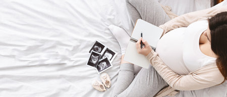 Pregnant woman making packing list for maternity hospital