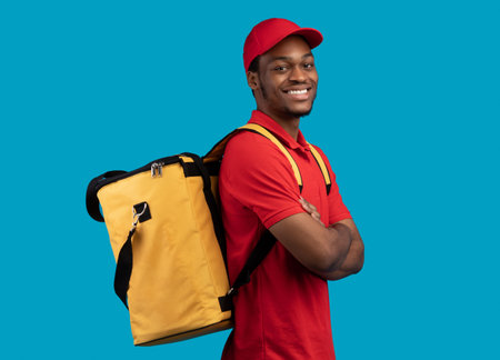 African american delivery man posing with thermo bagの写真素材