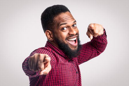 Positive Black Guy Pointing Fingers At Camera Over White Backgroundの写真素材