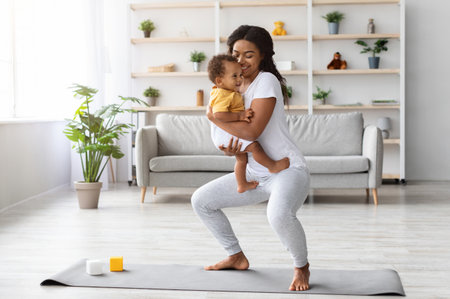 Postpartum Weight Loss. Happy Black Lady Making Squats With Baby On Handsの写真素材