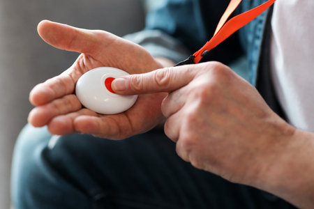 Man pushing panic button on emergency equipment for elderly people