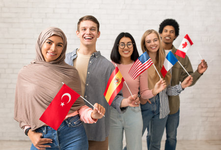 Modern exchange program and language learning. Happy young international students looking at cameraの写真素材