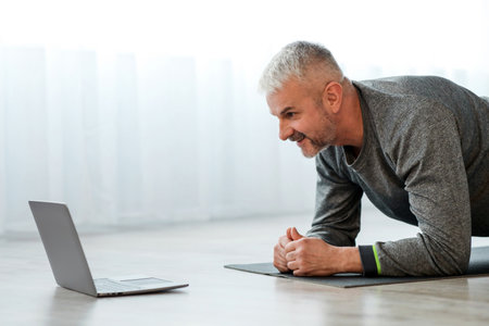 Closeup of senior man having online fitness classの写真素材