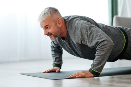 Closeup of elder man exercising at homeの写真素材