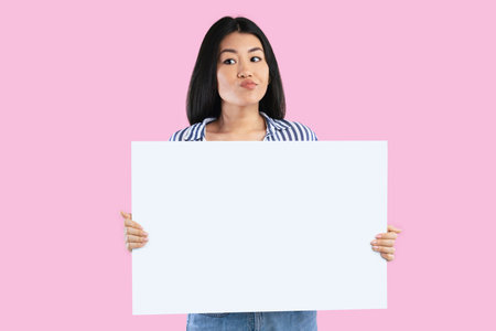 Asian lady holding blank white advertising boardの写真素材