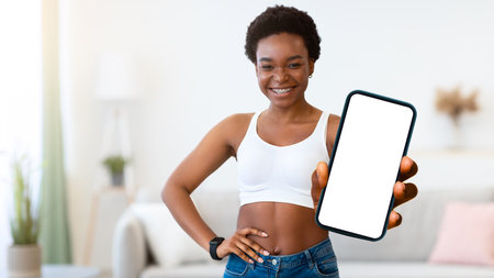 Skinny African Woman Posing With Broccoli Standing At Homeの写真素材