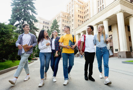 Free time of students. Friendly students walking after classesの写真素材
