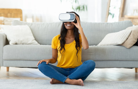 Virtual entertainments. Black woman in VR headset playing interactive video games, exploring...