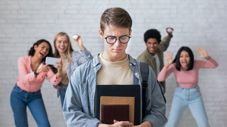 People in classroom bullied of depressed teenage guyの写真素材