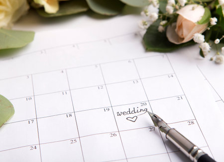 Wedding calendar with pen writing text on planning dateの写真素材