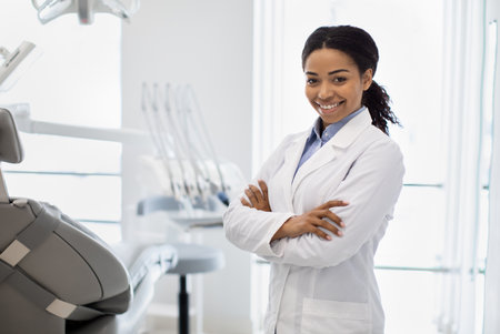 Portrait Of Smiling Black Female Stomatologist Posing In Dental Clinic Interiorの写真素材