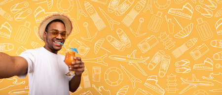 Enjoying a refreshing drink while capturing vacation memories with a smileの写真素材